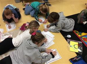 students fanned out at tables writing thank you letters to military families 